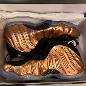 Nike Men’s Foamposite Metallic Bronze Sneakers
(One Copper)